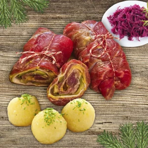Rouladenpaket: rohe und gefüllte Rinderrouladen mit Kartoffelknödeln und Rotkraut auf hellem Holzhintergrund